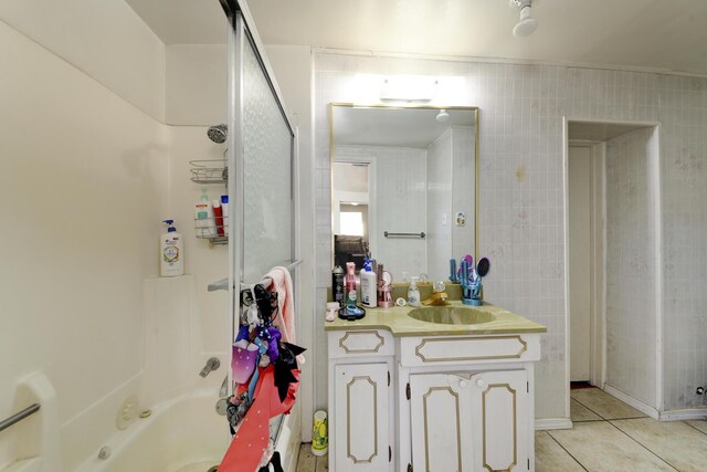 full bath featuring  shower combination, vanity, and tile patterned floors