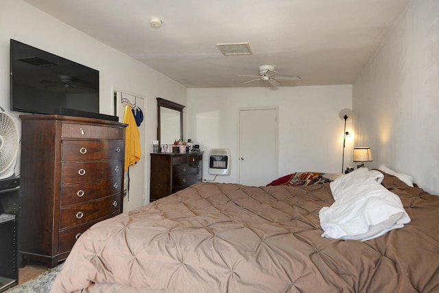 bedroom with heating unit and visible vents