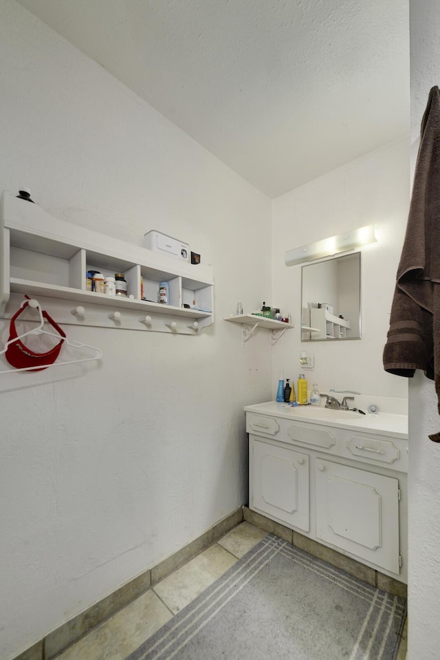 bathroom with vanity and baseboards