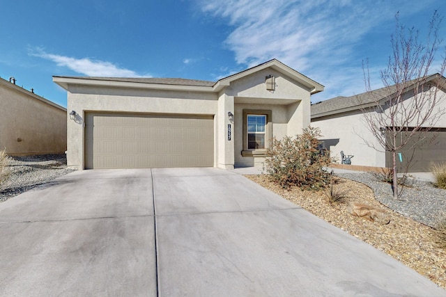 ranch-style house featuring a garage, driveway, and stucco siding