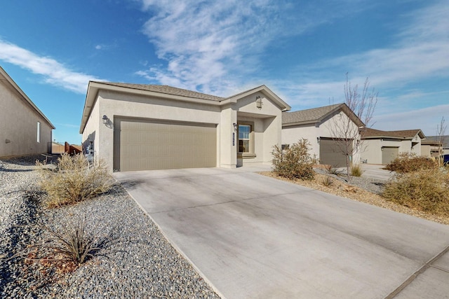 ranch-style home featuring an attached garage, driveway, and stucco siding