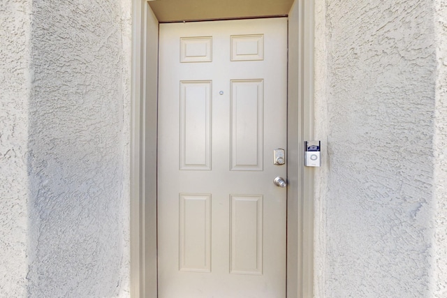 view of exterior entry with stucco siding