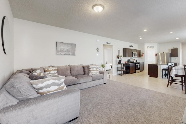 living area with recessed lighting and a textured ceiling