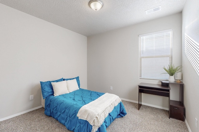 carpeted bedroom featuring visible vents, a textured ceiling, and baseboards