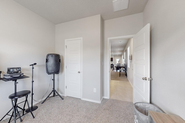 miscellaneous room with light carpet, visible vents, and baseboards