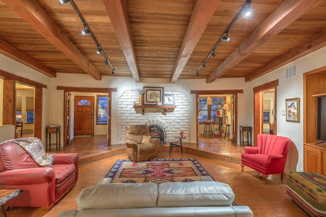 living area featuring rail lighting, wood ceiling, and visible vents