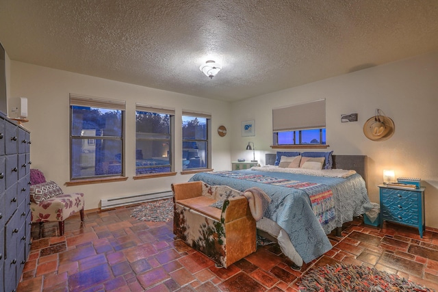 bedroom with a baseboard radiator and a textured ceiling