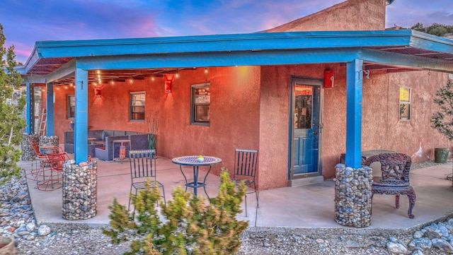 exterior space featuring stucco siding and a patio