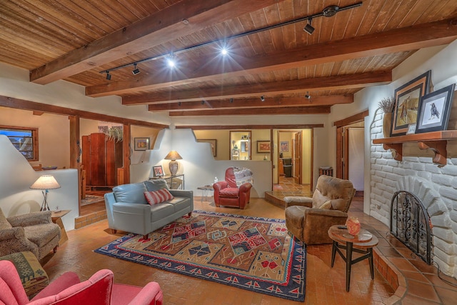 living room with brick floor, wood ceiling, a fireplace, and beamed ceiling