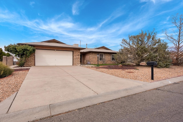 ranch-style home with an attached garage, driveway, and brick siding