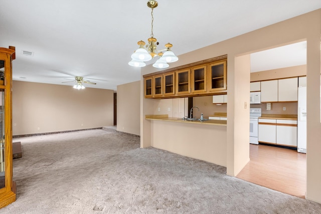 kitchen with light carpet, white appliances, visible vents, white cabinets, and glass insert cabinets