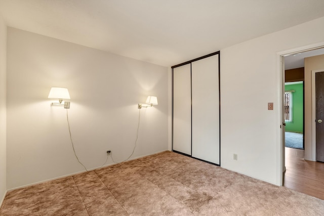 unfurnished bedroom featuring a closet and carpet flooring