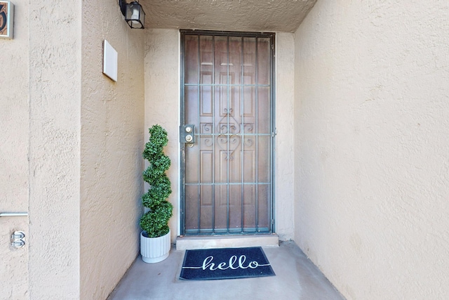 entrance to property featuring stucco siding