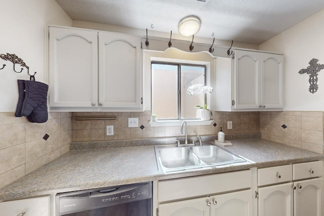 kitchen featuring a sink, white cabinetry, light countertops, decorative backsplash, and dishwasher