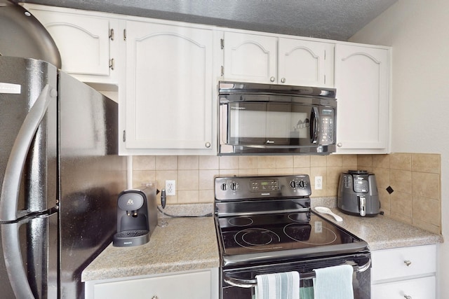 kitchen with black appliances, white cabinetry, and light countertops