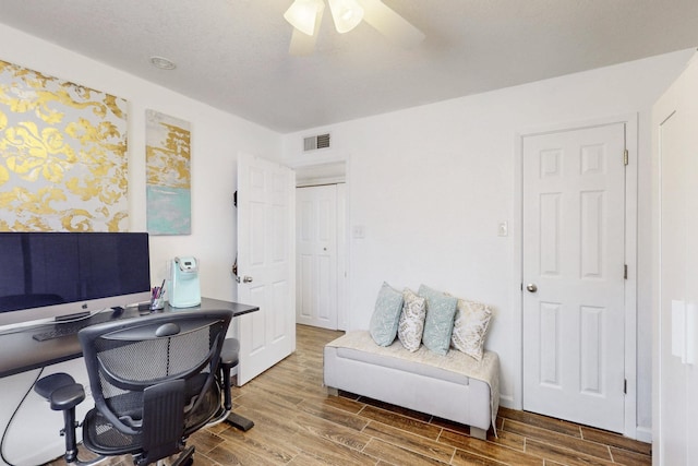 home office featuring ceiling fan, wood finish floors, and visible vents