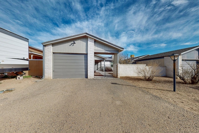 garage with fence and driveway