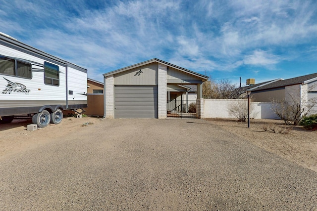 exterior space featuring driveway and fence