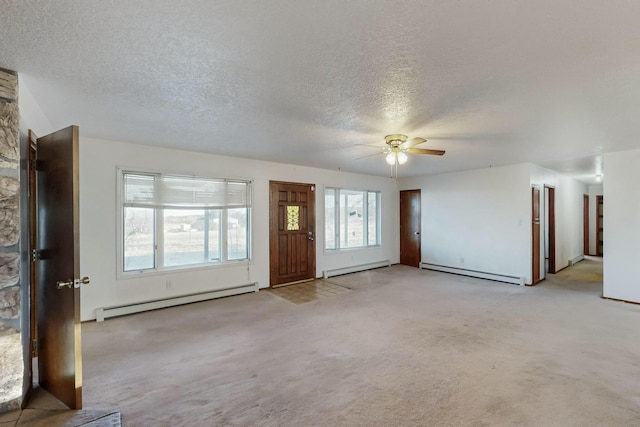 interior space with light carpet, baseboard heating, and a textured ceiling