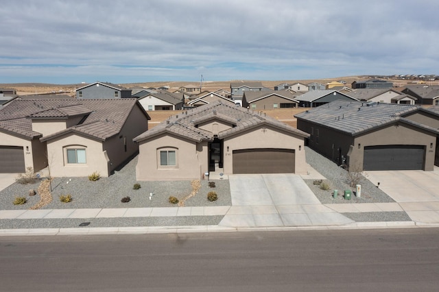 view of front of home featuring stucco siding, a residential view, concrete driveway, and a tile roof