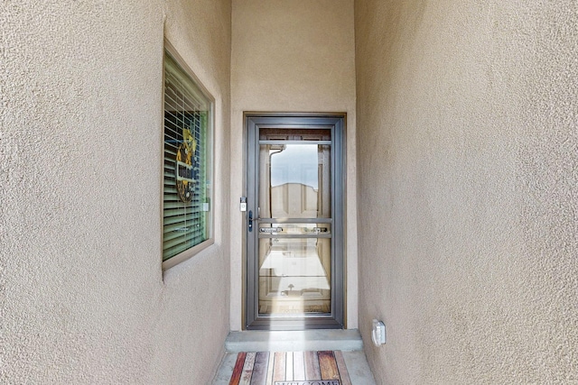 view of exterior entry featuring stucco siding