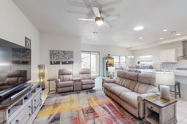 living area with light tile patterned flooring, visible vents, recessed lighting, and ceiling fan