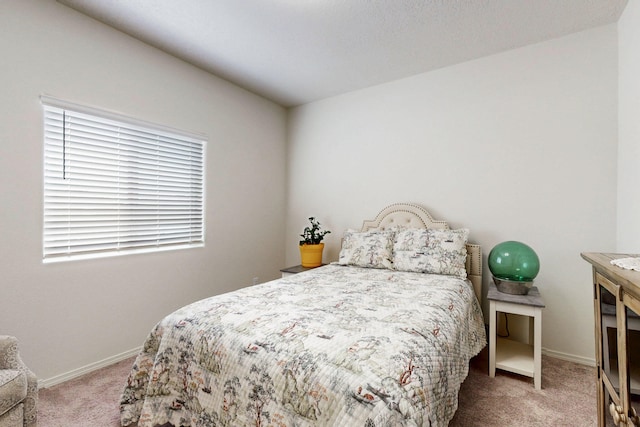 carpeted bedroom featuring baseboards