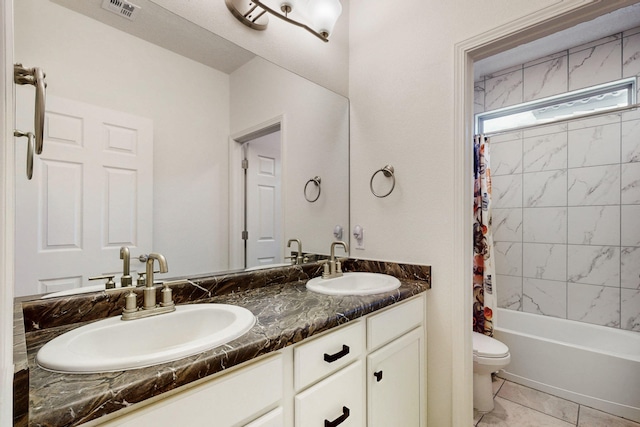 full bathroom with toilet, a sink, visible vents, and double vanity