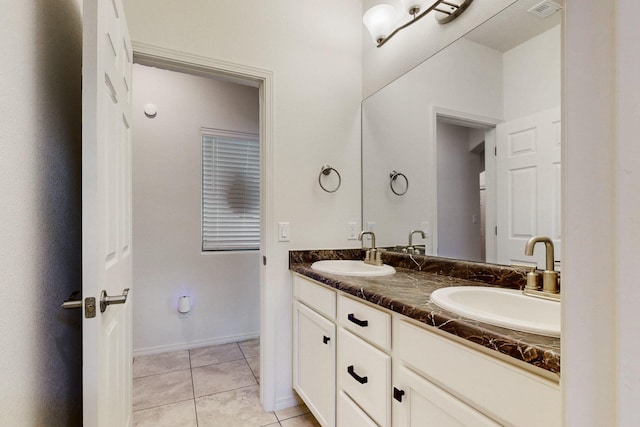 bathroom featuring tile patterned flooring, a sink, visible vents, and double vanity