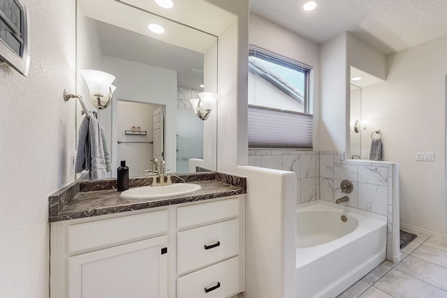 bathroom with recessed lighting, a garden tub, vanity, and tile patterned flooring