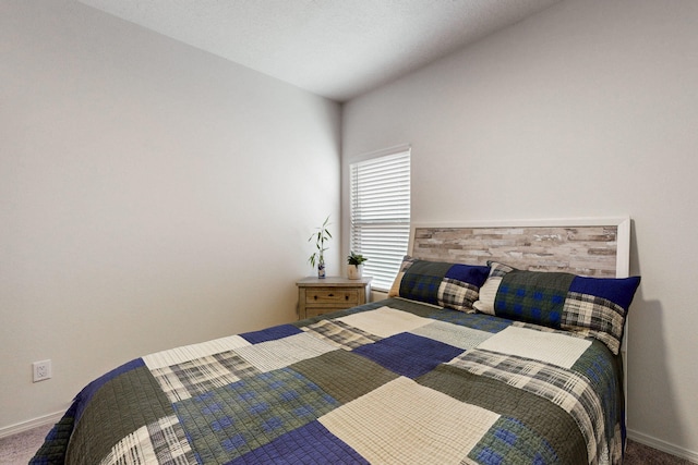 carpeted bedroom featuring baseboards