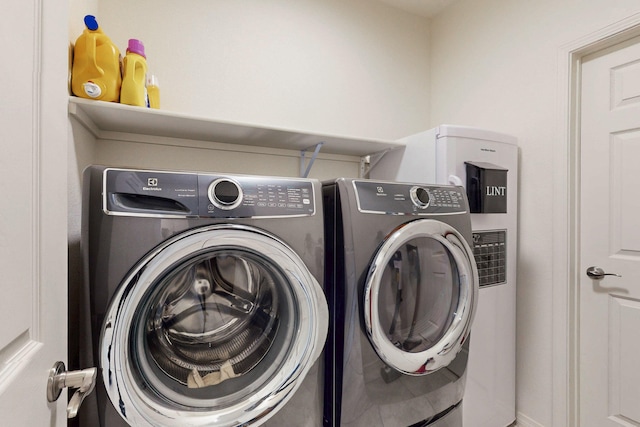 laundry area with washer and clothes dryer and laundry area