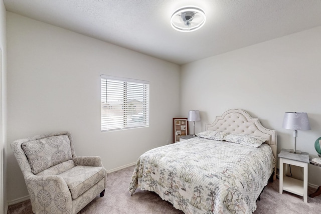 carpeted bedroom with baseboards and a textured ceiling