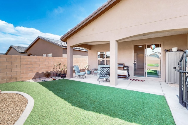 view of yard with fence and a patio