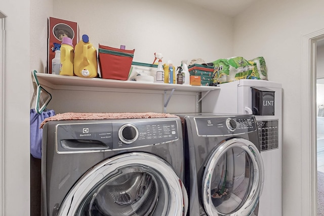 washroom with washing machine and dryer and laundry area