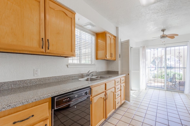 kitchen featuring dishwasher, light brown cabinetry, and a sink