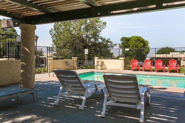 pool featuring a patio area and fence