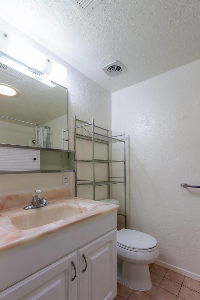 full bathroom featuring visible vents, a textured wall, tile patterned flooring, a textured ceiling, and vanity