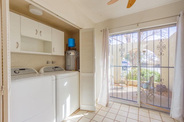 washroom with light tile patterned floors, cabinet space, ceiling fan, water heater, and separate washer and dryer