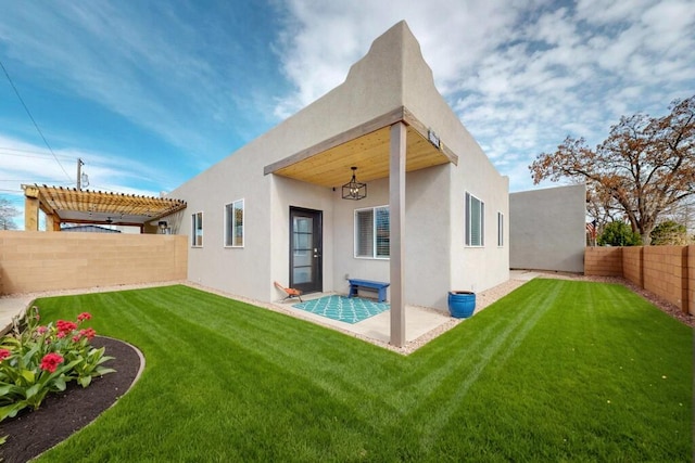 back of house featuring a patio, a lawn, stucco siding, and a pergola