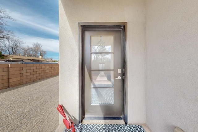 property entrance with stucco siding