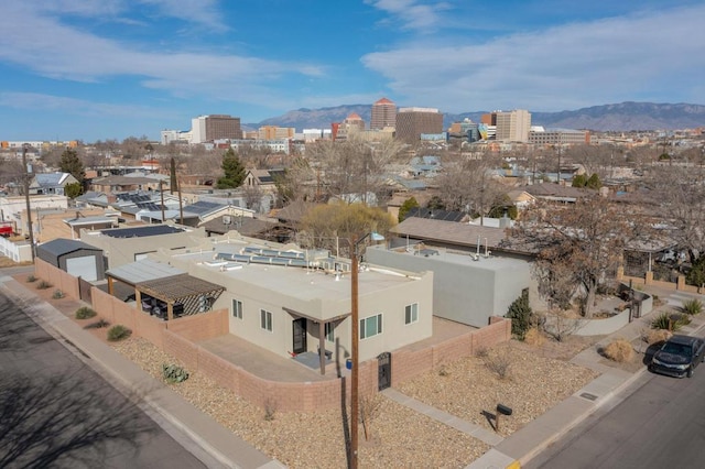 drone / aerial view featuring a view of city and a mountain view