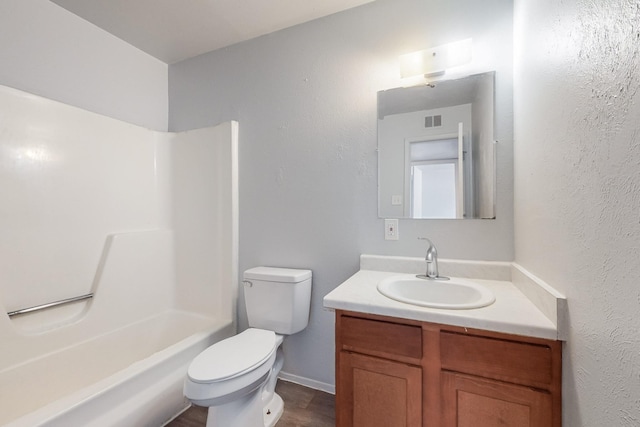 full bath featuring baseboards, visible vents, toilet, tub / shower combination, and vanity