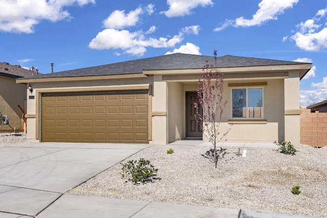 view of front of house featuring a garage, driveway, fence, and stucco siding