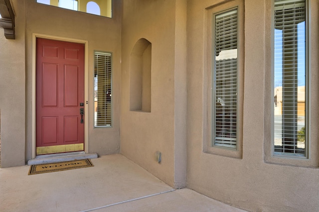 entrance to property with stucco siding