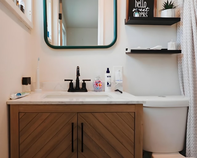 bathroom with toilet and vanity