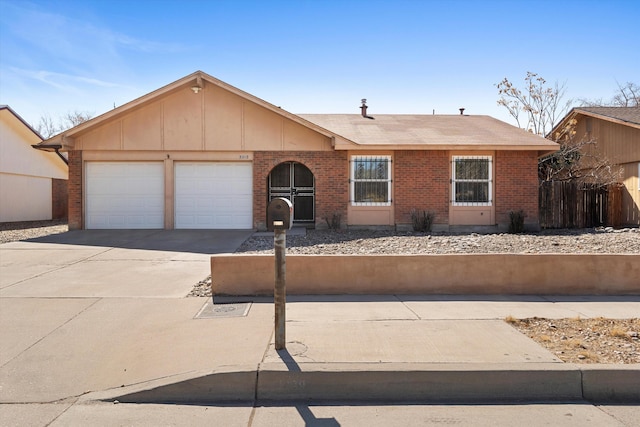 single story home featuring concrete driveway, brick siding, and an attached garage