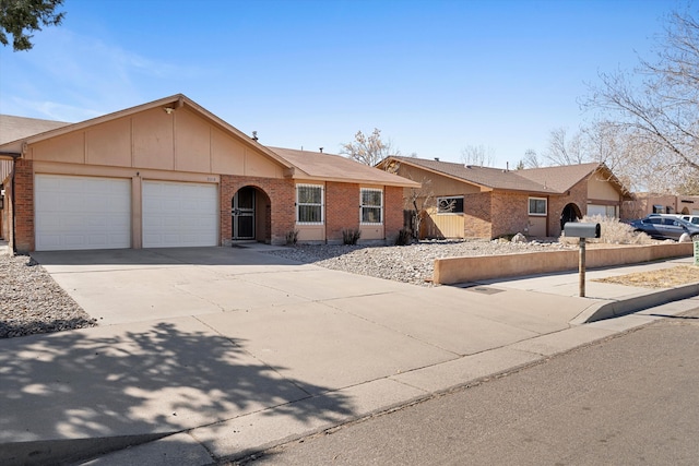 single story home with driveway, brick siding, an attached garage, and fence