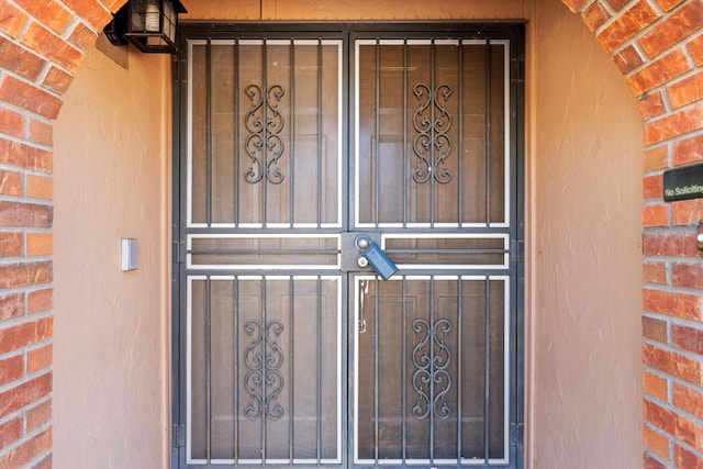 entrance to property featuring brick siding