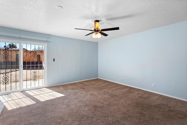 empty room featuring a ceiling fan, carpet, baseboards, and a textured ceiling